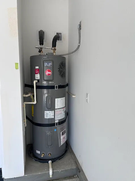 Advanced energy-efficient hybrid heat pump electric water heater installation executed to clinical engineering standards in a residential home.
