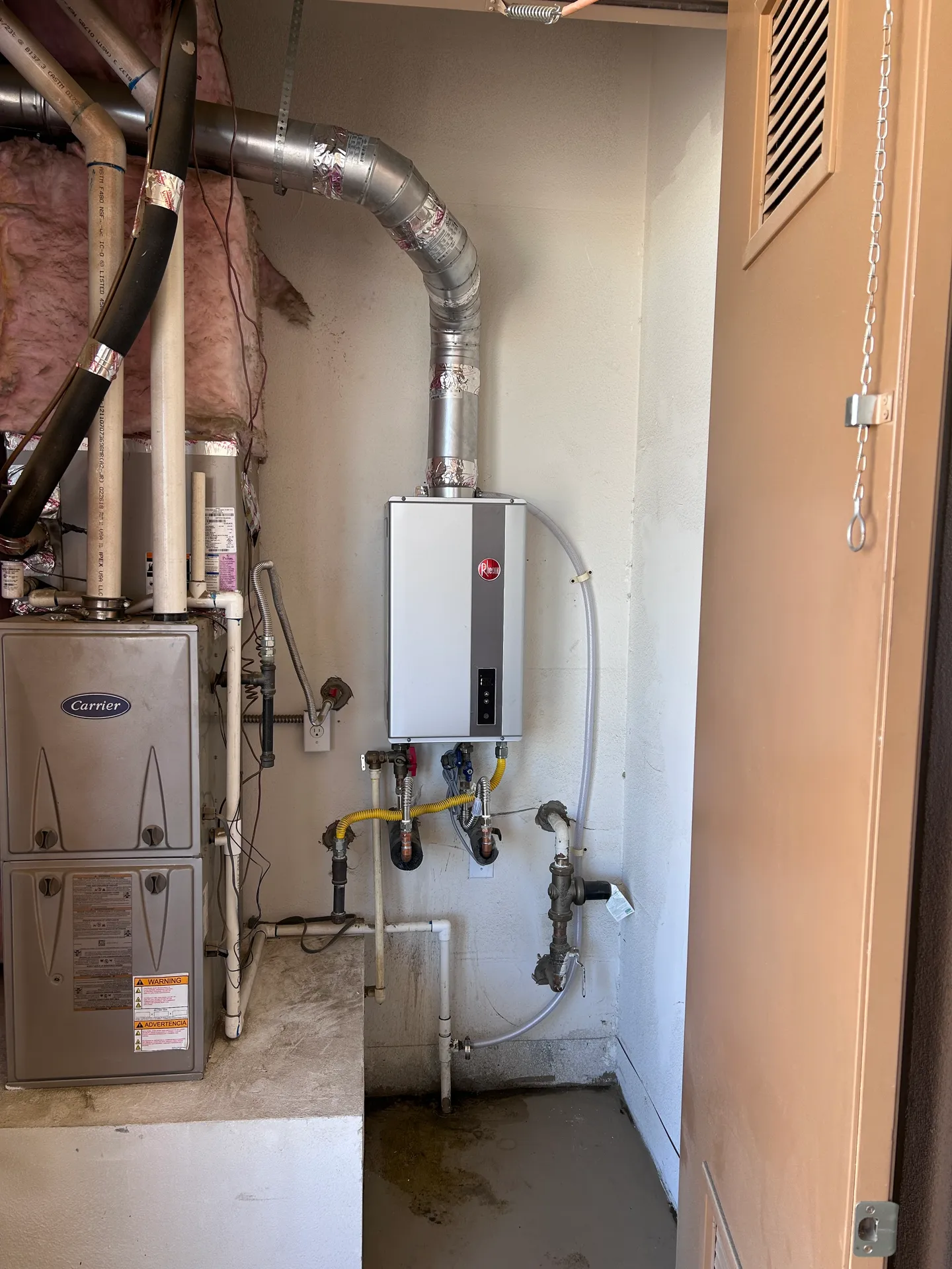New high-efficiency wall-mounted tankless water heater installation with clean isolation valves, seamlessly integrated with home mechanical systems.