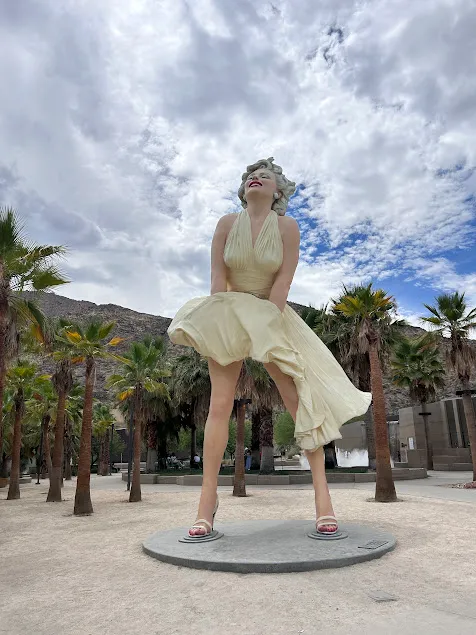 The iconic Marilyn Monroe statue in downtown Palm Springs, representing the historic culture and luxury lifestyle of the local desert community.
