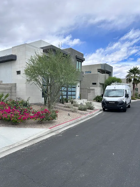 An Accurate One service van parked on a paved driveway at a luxury residential property, providing specialized water heater installations in La Quinta.