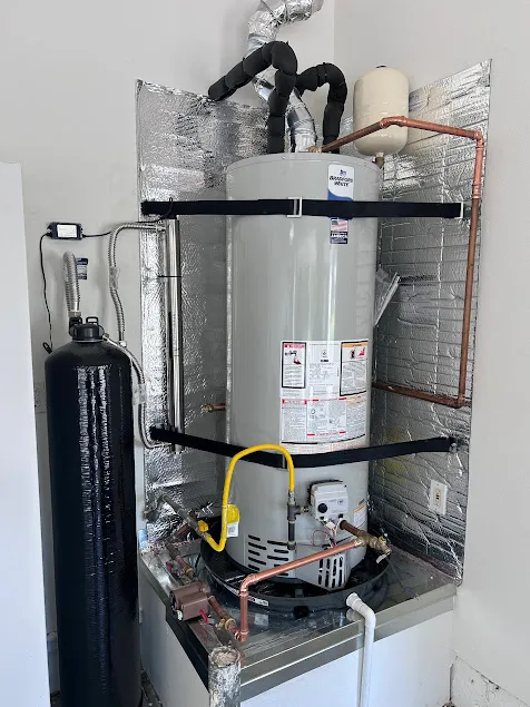 Professional installation of a whole-house water conditioning softener system integrated alongside a high-efficiency tankless water heater for a Coachella Valley residence.