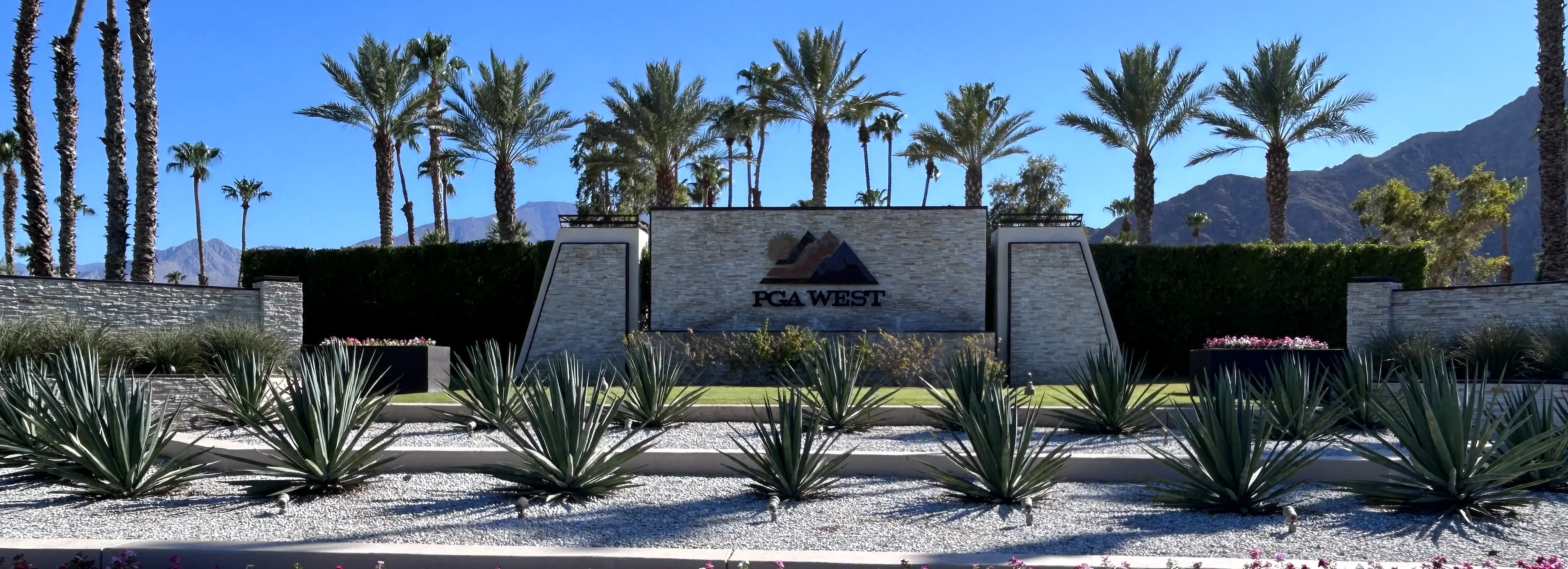 "PGA West luxury estate entrance in La Quinta, featuring custom ledger stone signage and premium landscaping—serviced by Accurate One Construction water heater and water filtration division.