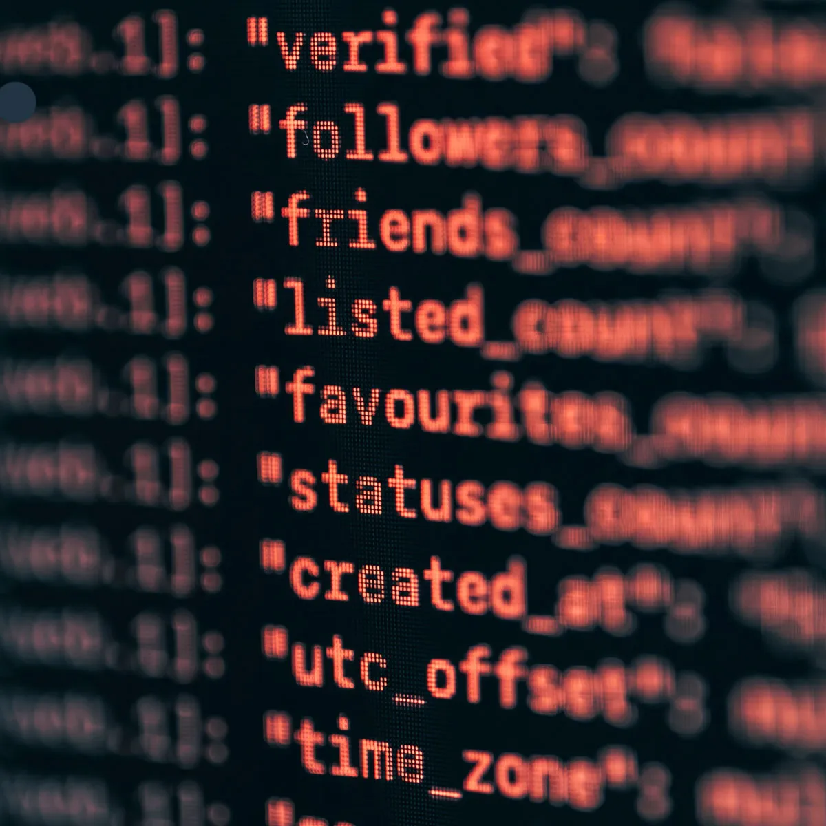 Close-up of a Prolog-style software interface with red glowing code and data fields on a dark screen.