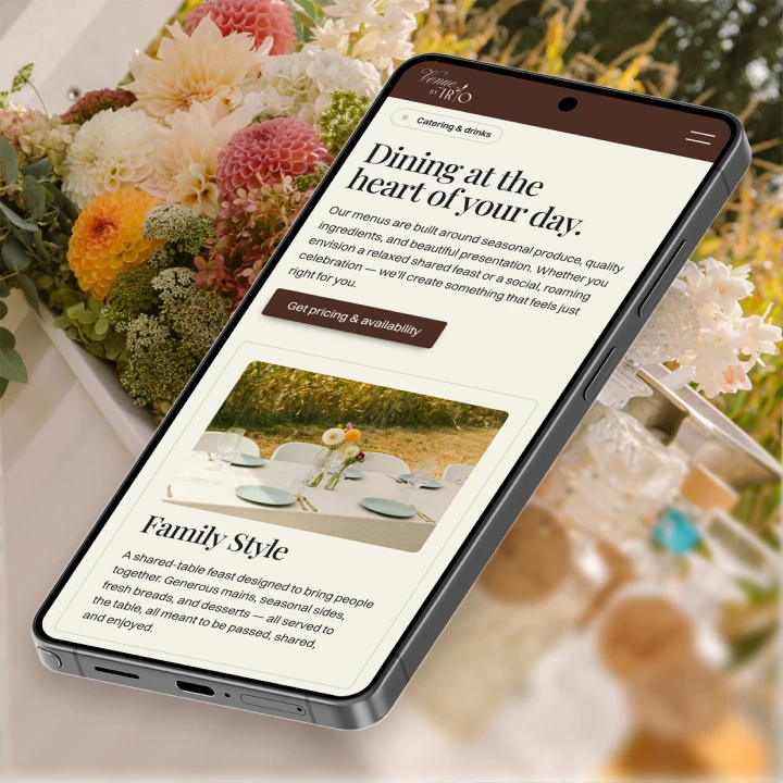 Smartphone displaying a catering menu with flowers and table setting blurred in the background.