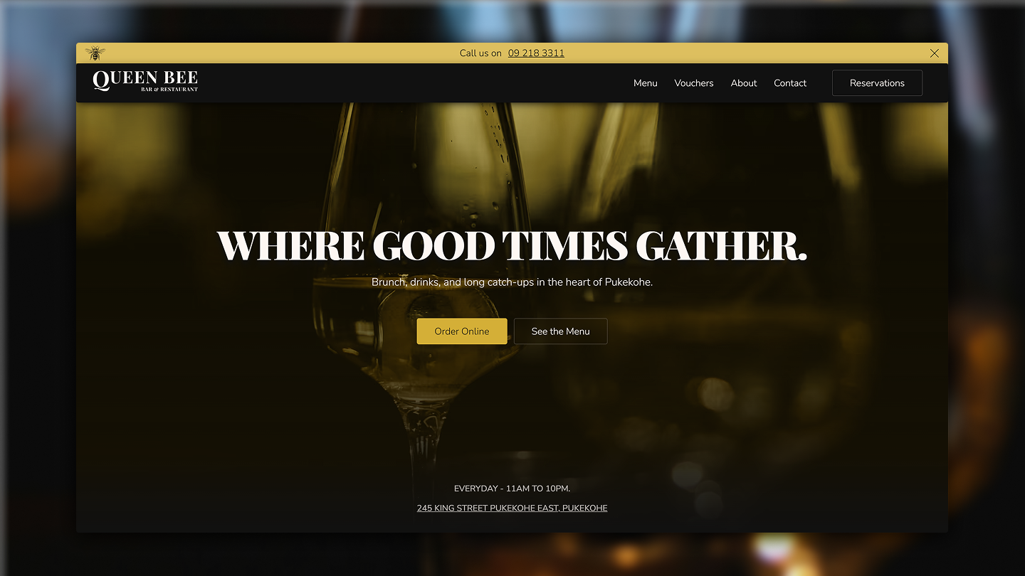 Queen Bee Bar & Restaurant website homepage with navigation and call to action buttons.