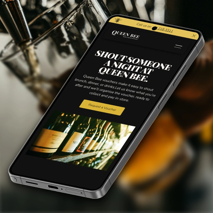Smartphone displaying Queen Bee bar's voucher request webpage with wine bottles image.