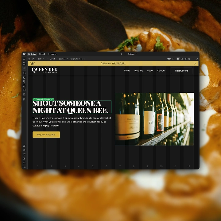 Website with text 'Shout someone a night at Queen Bee' and a photo of wine bottles on a wooden shelf.