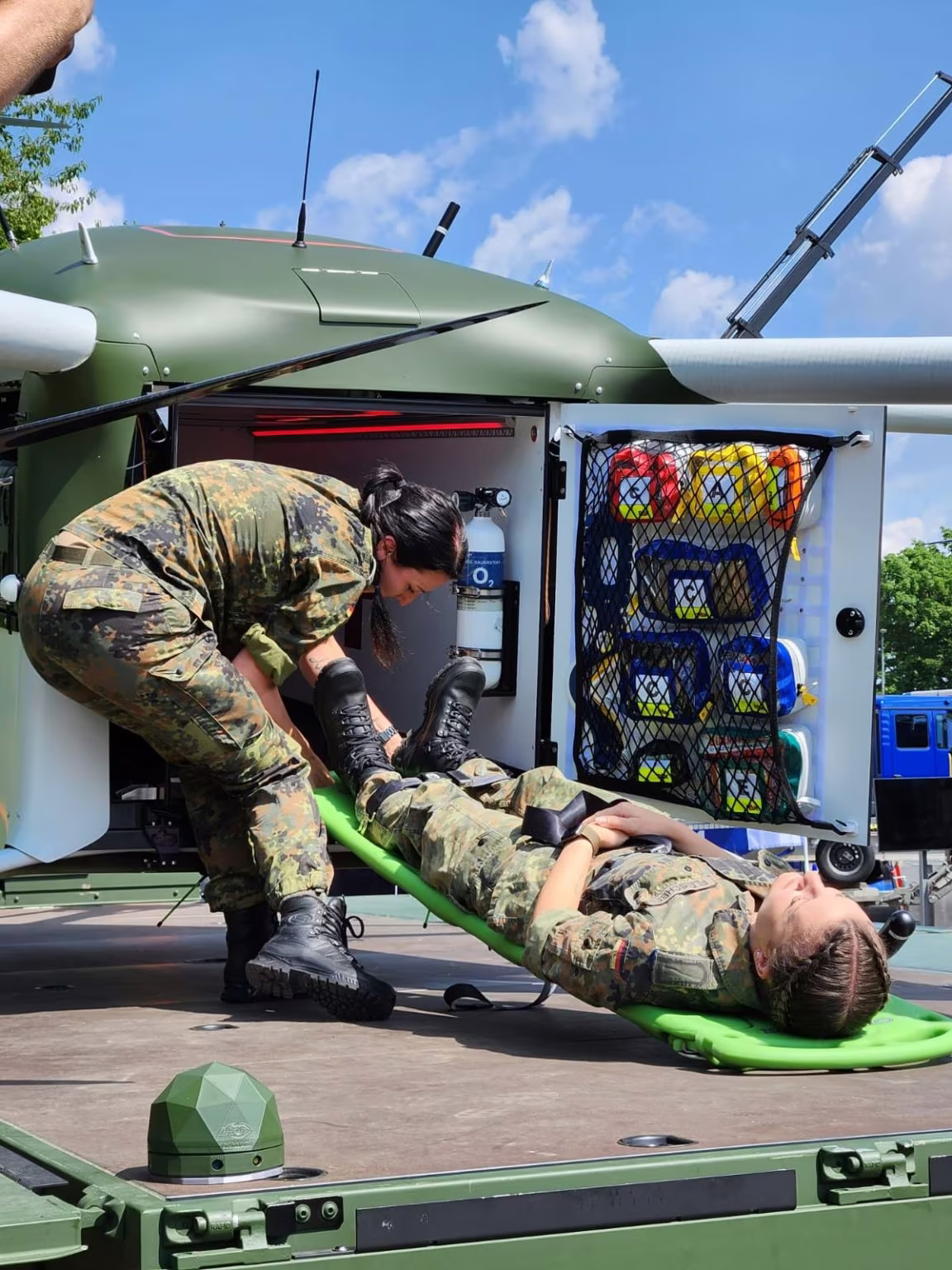 Medic securing a patient inside the Grille medical cabin
