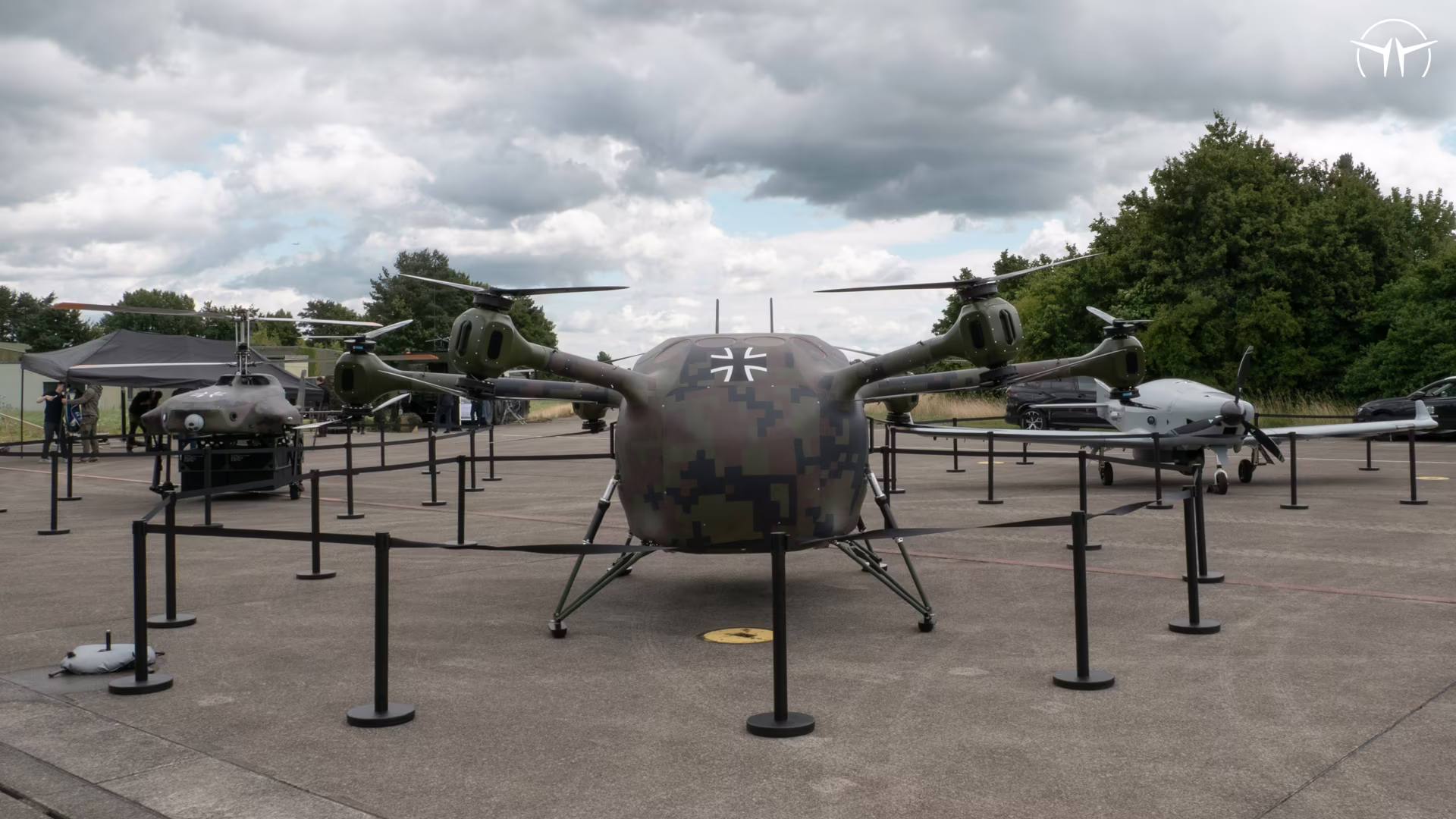 Grille drones lined up on the apron behind barrier ropes