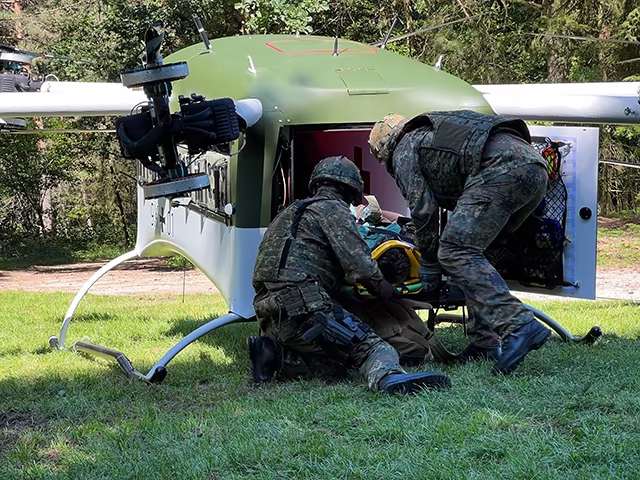 Medics loading a patient into the Grille cabin in the woods
