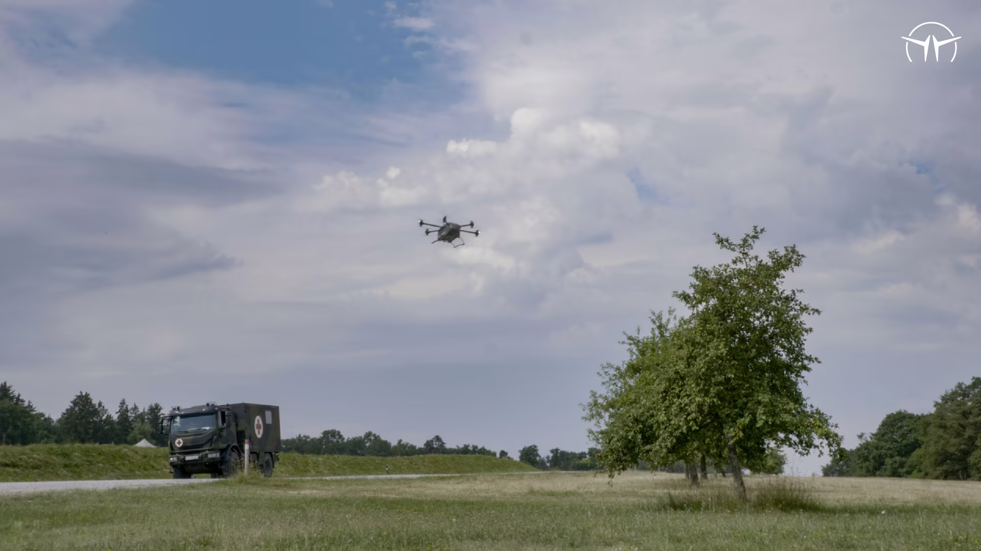 Grille drone approaching a landing zone with a truck in the background