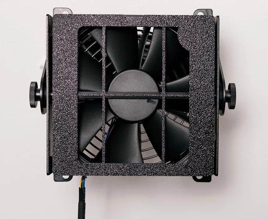 Black fan with textured square frame and blades, side knobs, and cable attached at bottom