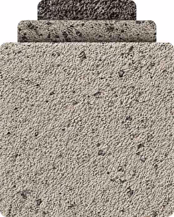 Three rectangular stone blocks stacked from largest at bottom to smallest top, each with rough texture.