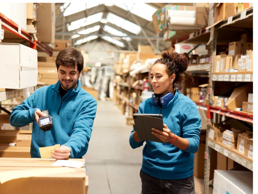 Two workers scanning stock in an aisle
