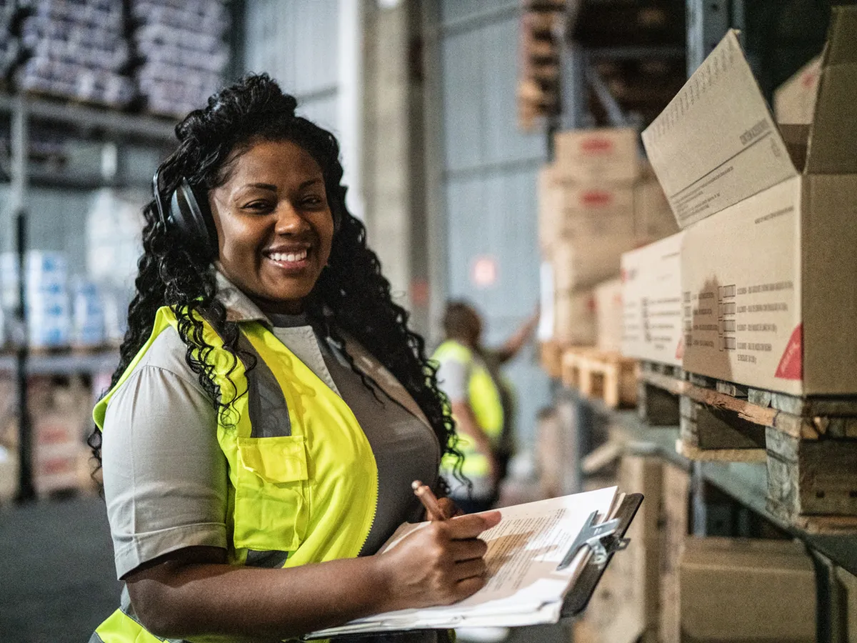 Warehouse worker checking inventory on a clipboard