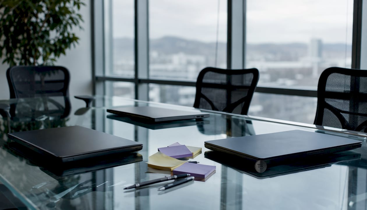 Meeting table with laptops and brochures