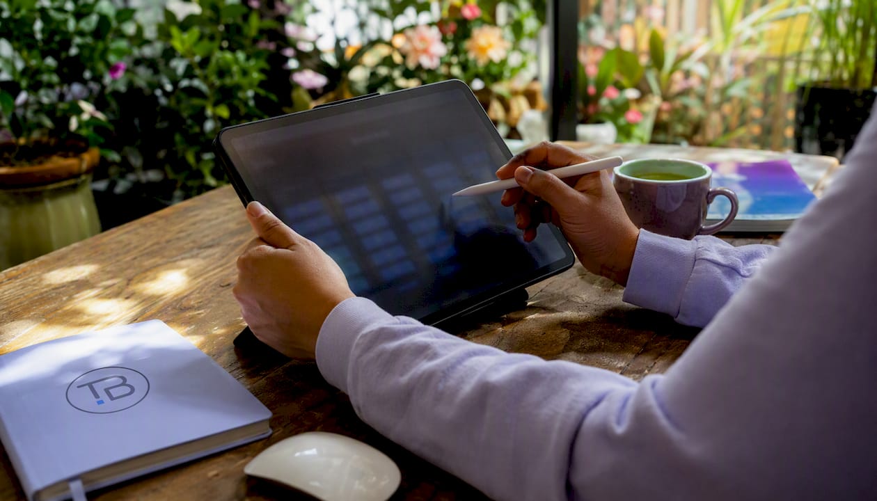 Hands using tablet with phone number pool interface