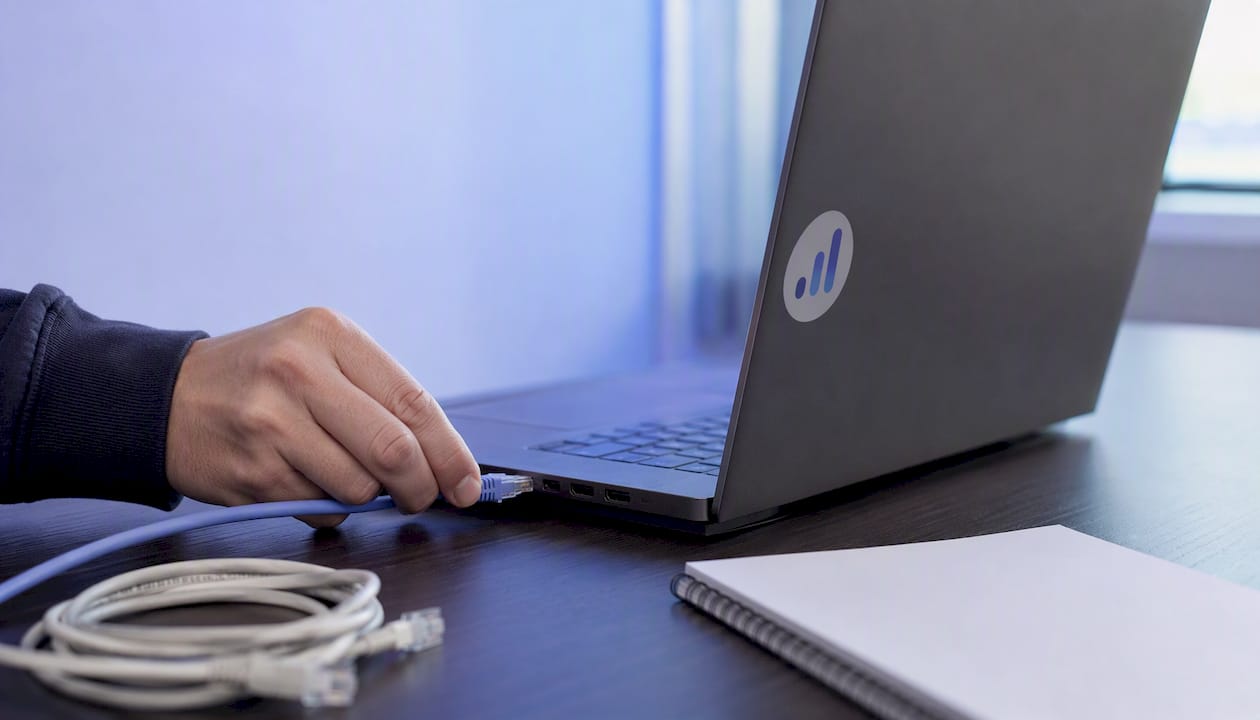 Manual cable unplugging on tidy desk setup
