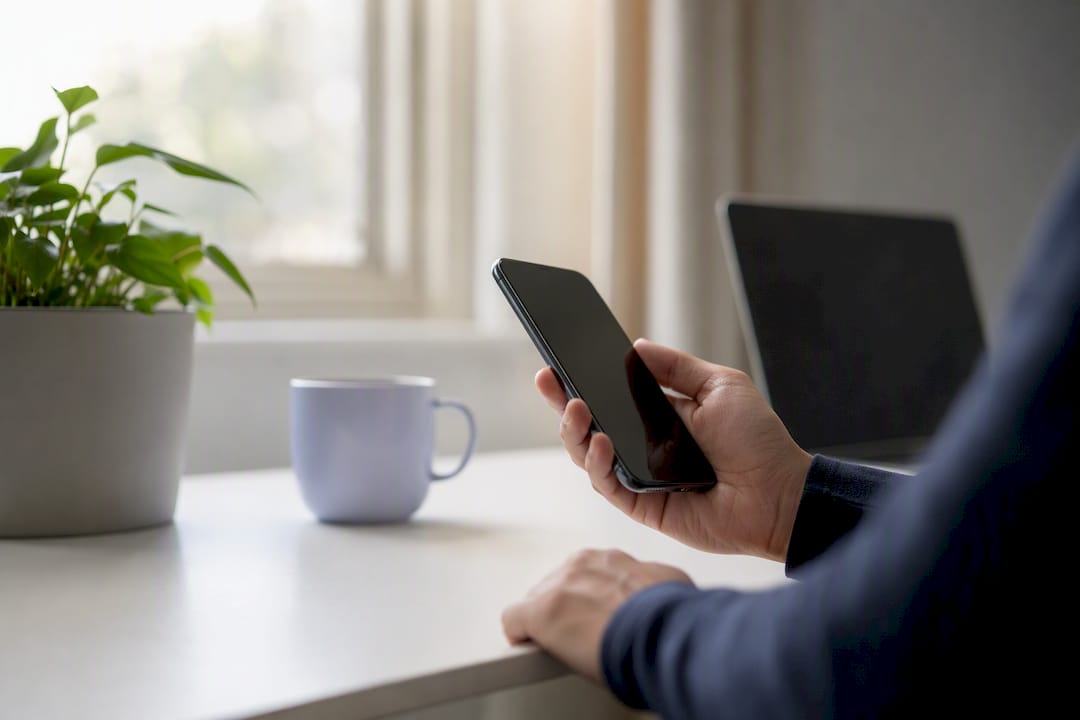 Hand holding smartphone before review reply