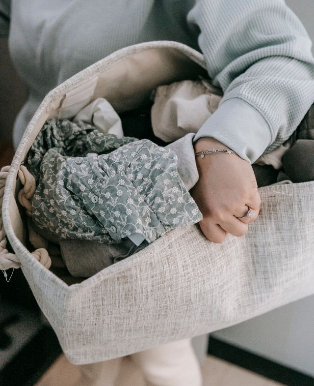 woman holding laundry basket, new mom, wife, busy person doing laundry