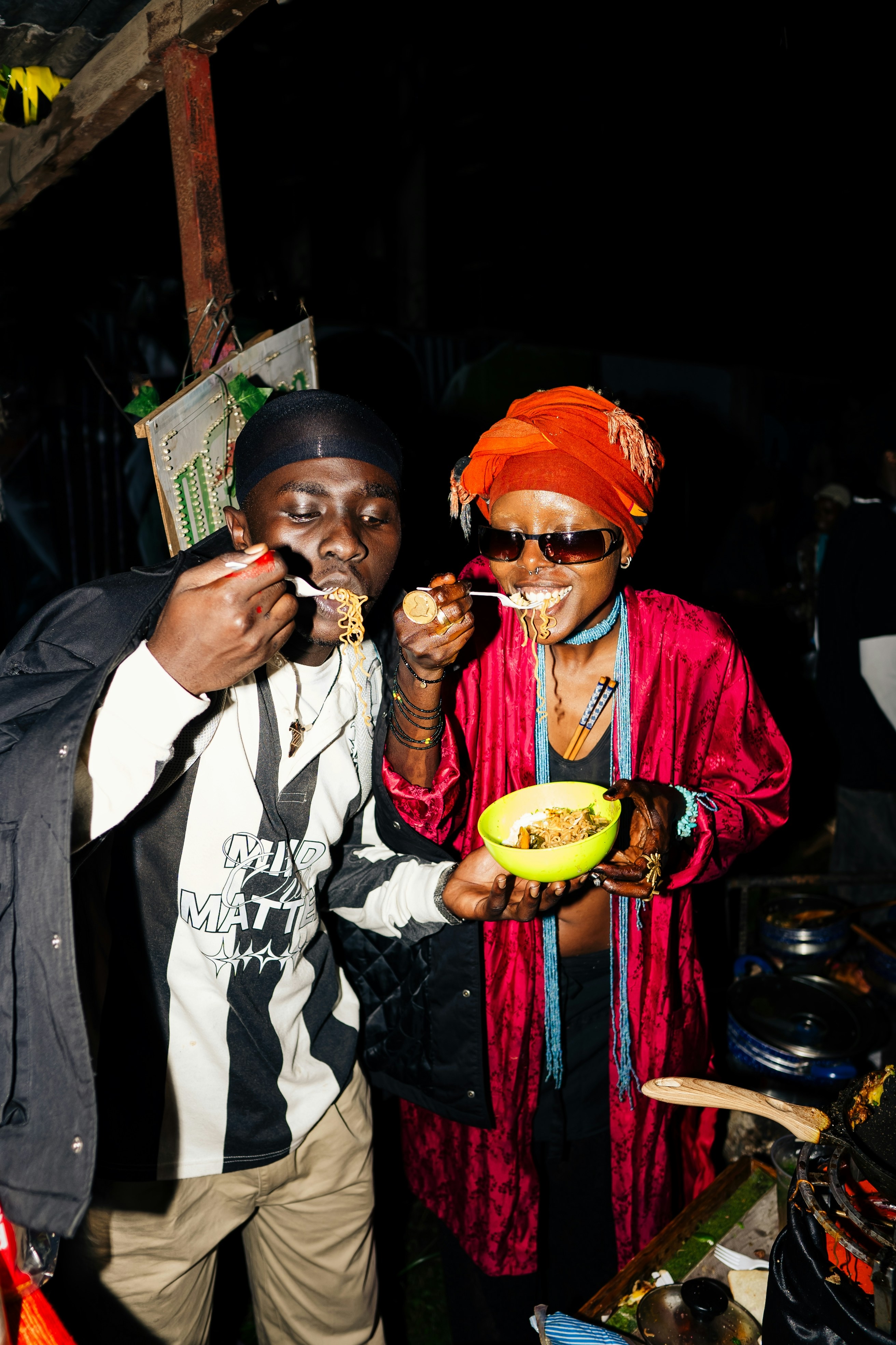 Couple eating noodles together at night