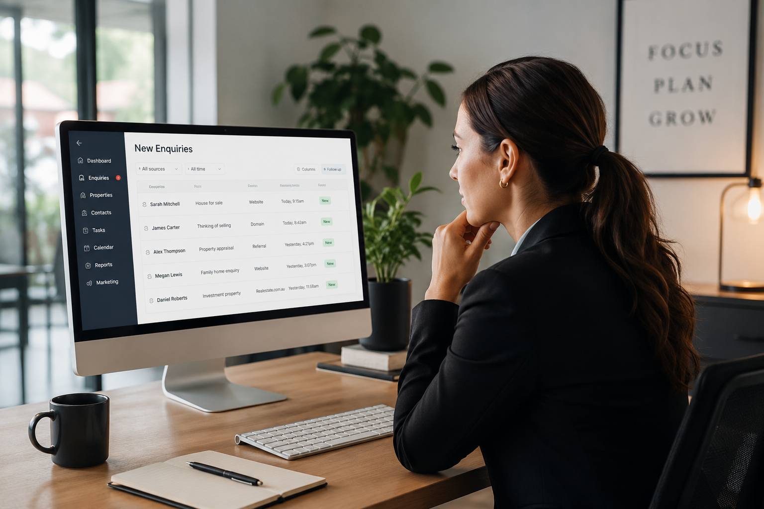 Real estate professional reviewing new enquiries on a computer