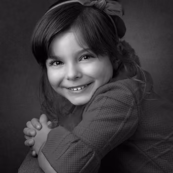 Timeless studio portrait of a young girl against a simple background by Plano children's photographer Larry Lourcey.