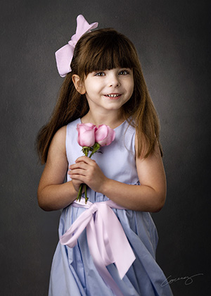Portrait of child with flowers by Plano photographer Larry Lourcey