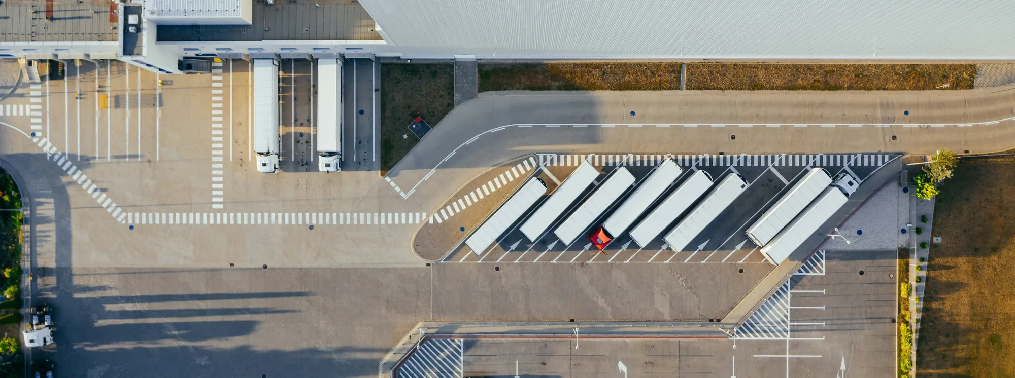 Aerial view of trailers backed into loading docks and staged in the yard at a distribution center