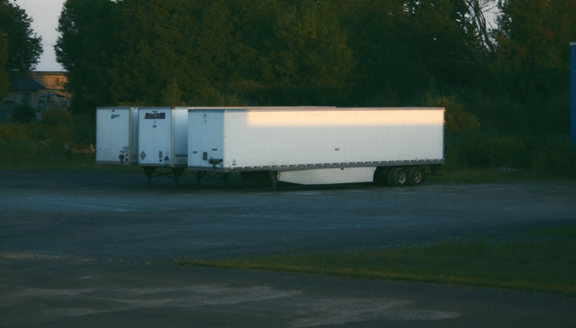 Unattended freight trailers parked in an empty lot at dusk