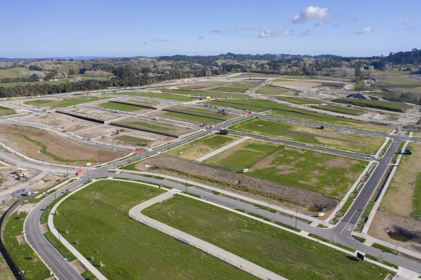 Aerial view of a residential subdivision under construction with roads, kerbs and drainage in place