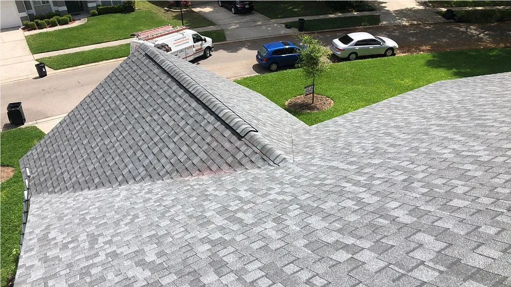 Aerial view of a Central Florida home roof with a JTO work vehicle on site for storm damage support