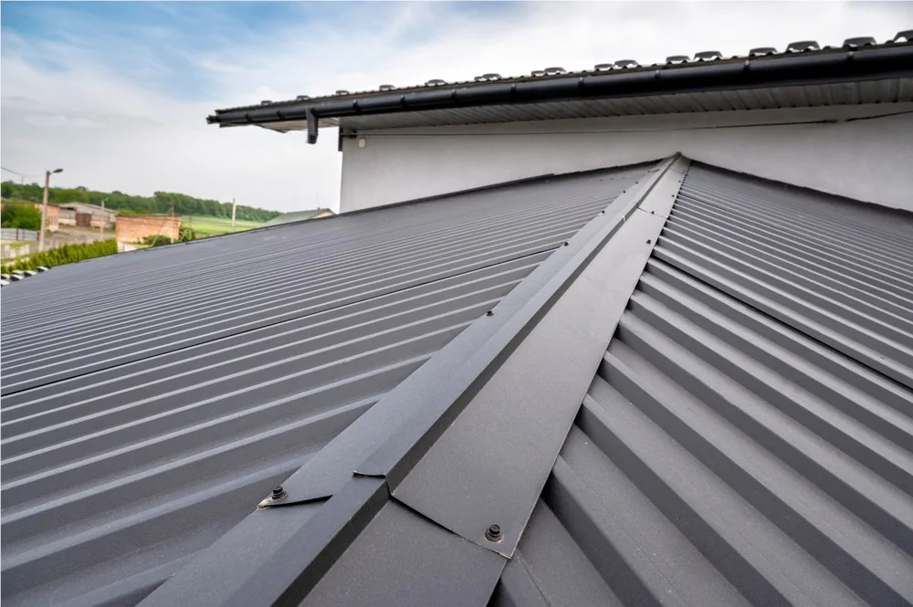 Dark standing-seam metal roof on a residential home installed by JTO Roofing