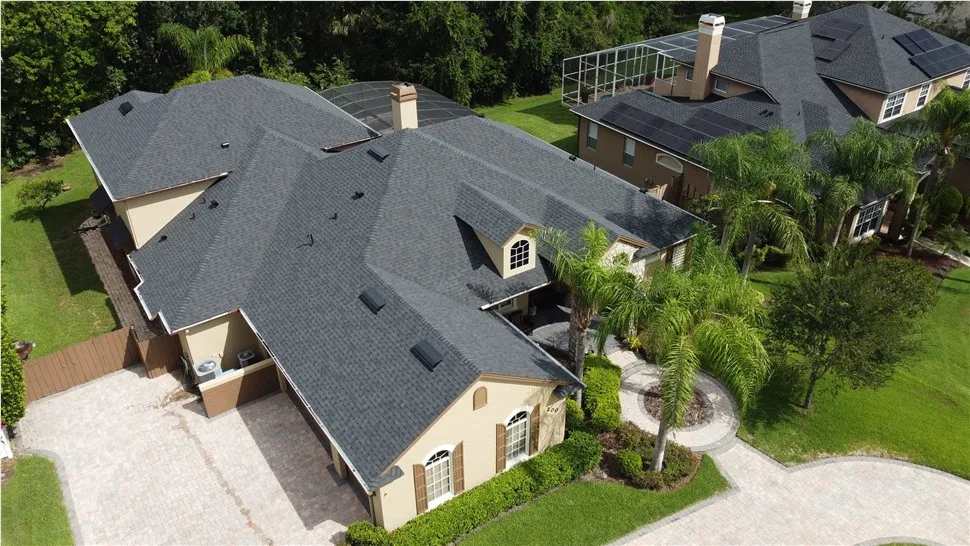 Aerial view of a completed asphalt shingle roof replacement on a Central Florida home