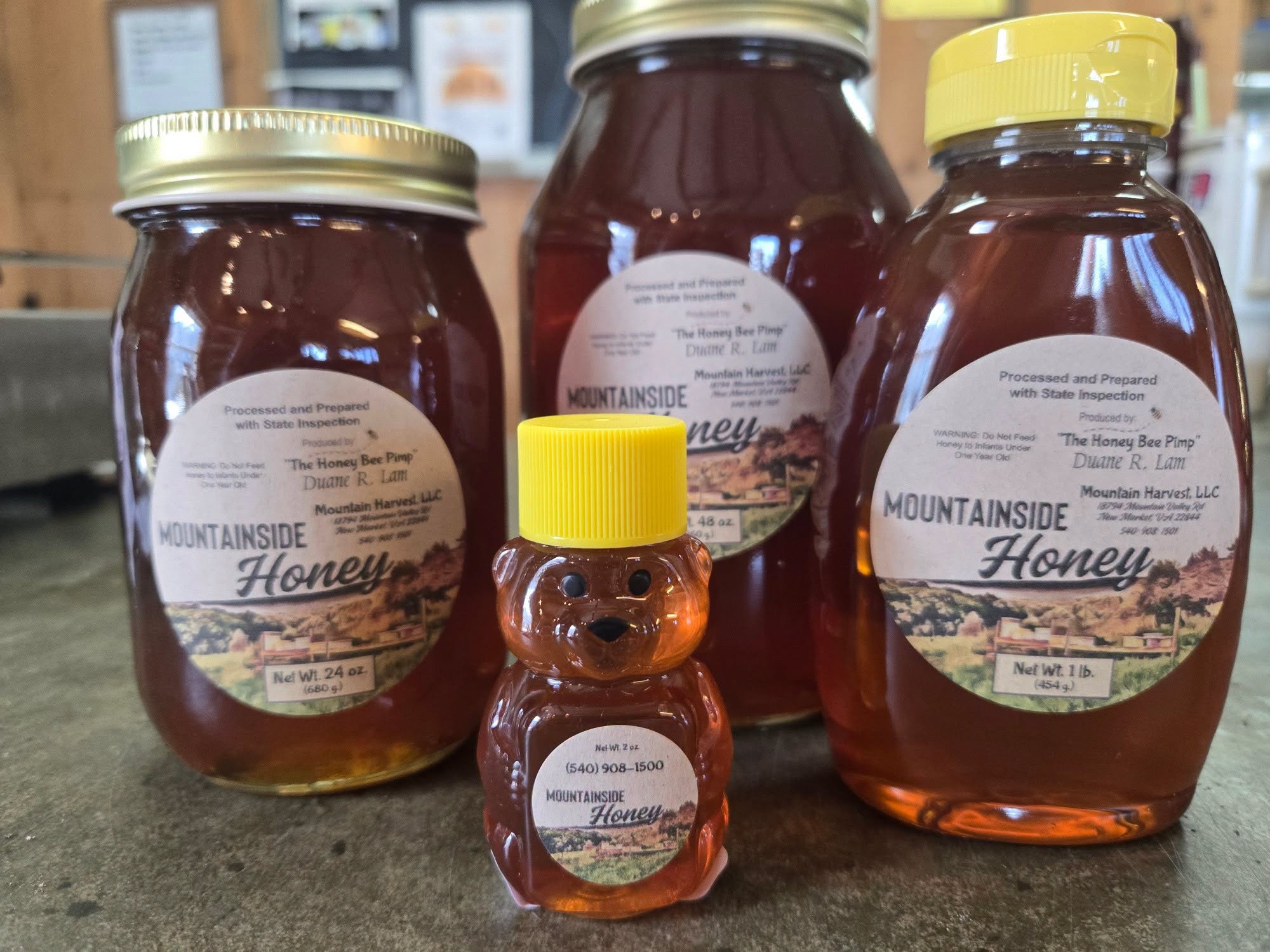 Four containers of Mountainside Honey, including a small honey bear bottle with a yellow cap.
