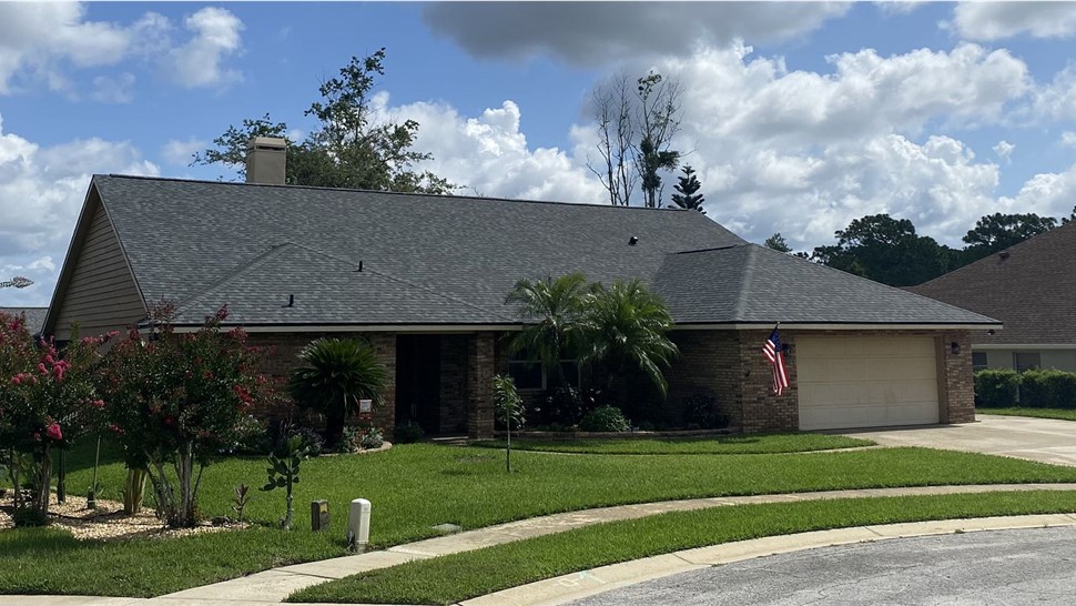 Completed gray architectural shingle roof on a brick ranch home in Oviedo, Florida