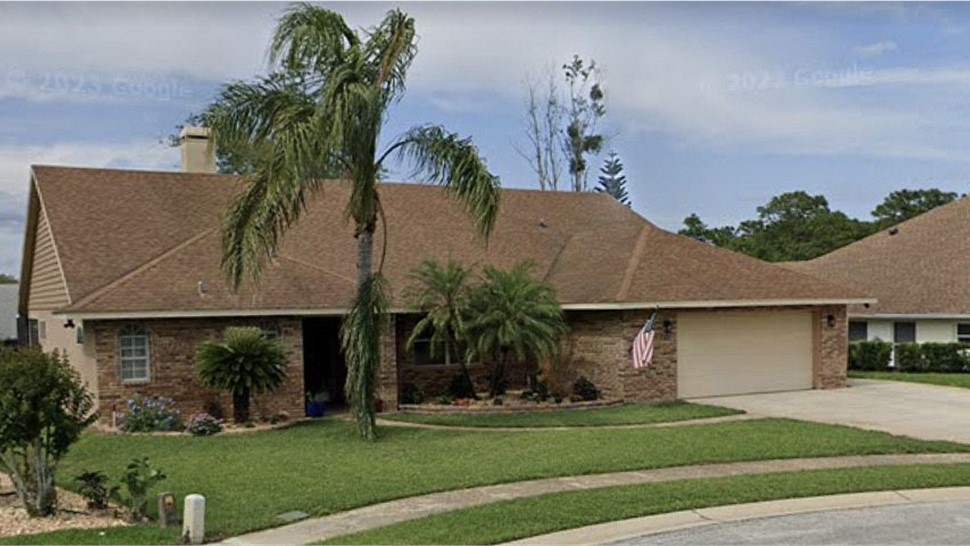Faded brown shingle roof before replacement on a brick ranch home in Oviedo, Florida