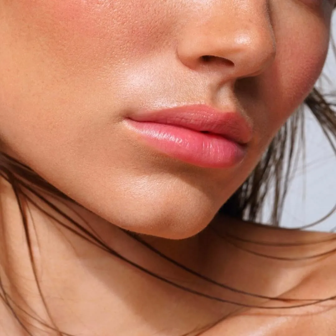 Close-up of smooth, glowing skin and full lips