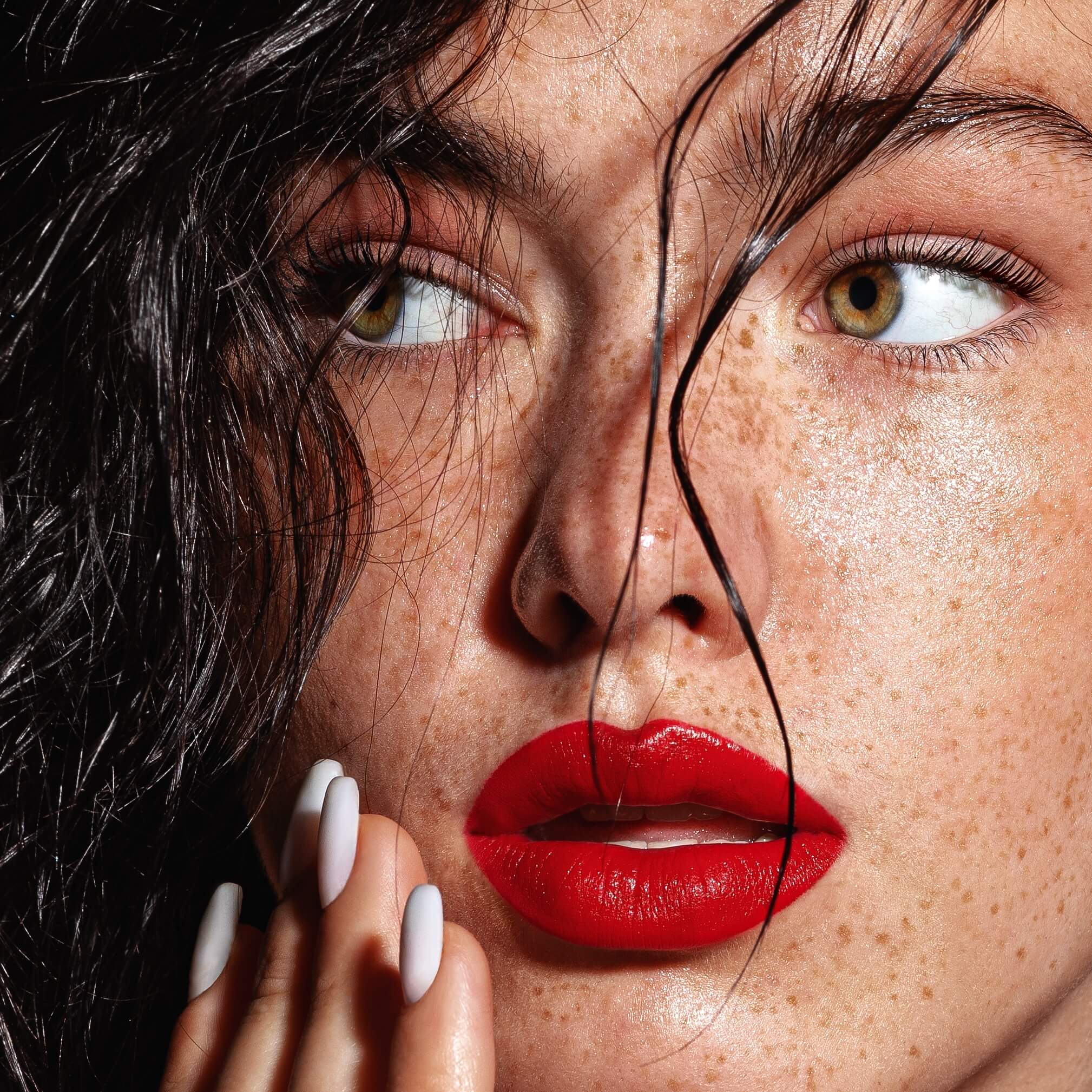 Woman with freckled, glowing skin
