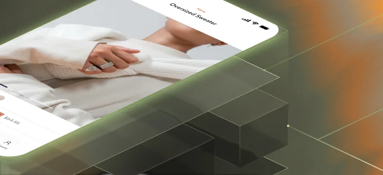 Native app product screen for an oversized sweater on a phone tilted over a dark geometric platform.
