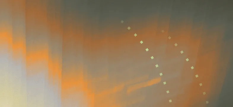 Abstract orange and grey gradient background with a curved dotted arc of small squares.