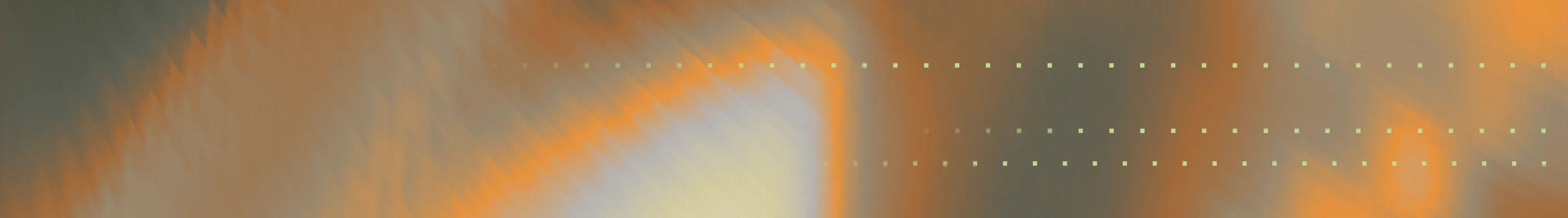 Abstract blurred gradient background in gray with warm orange tones.