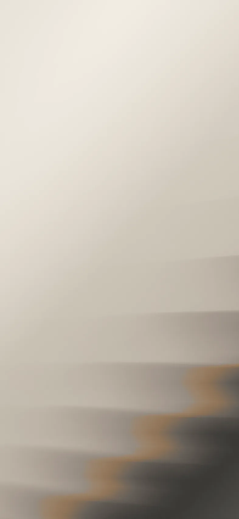 Blurred abstract image with gradient shades of beige, gray, and brown forming horizontal bands.