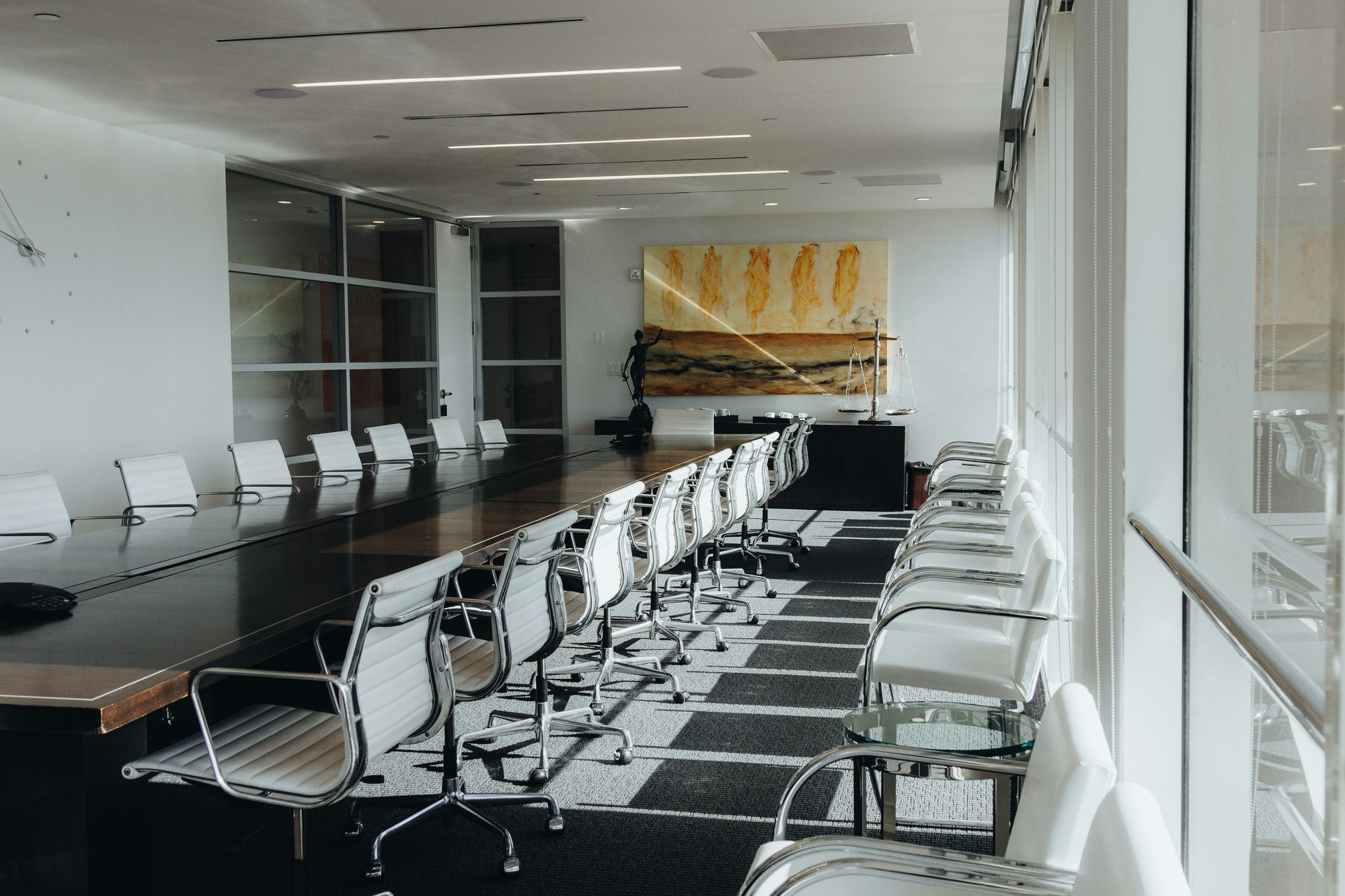 Empty modern boardroom with a long conference table