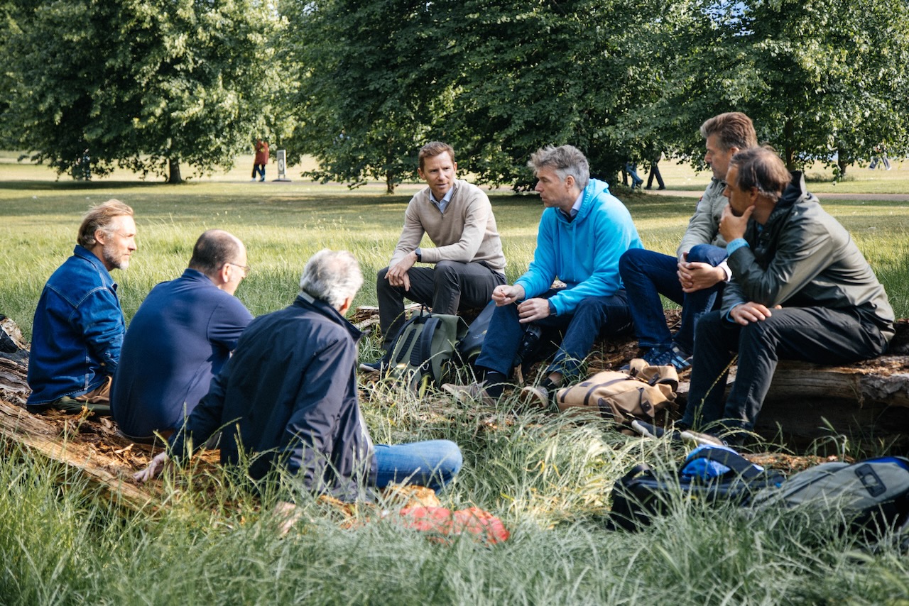 Monumental members walking together through the UK countryside on a retreat