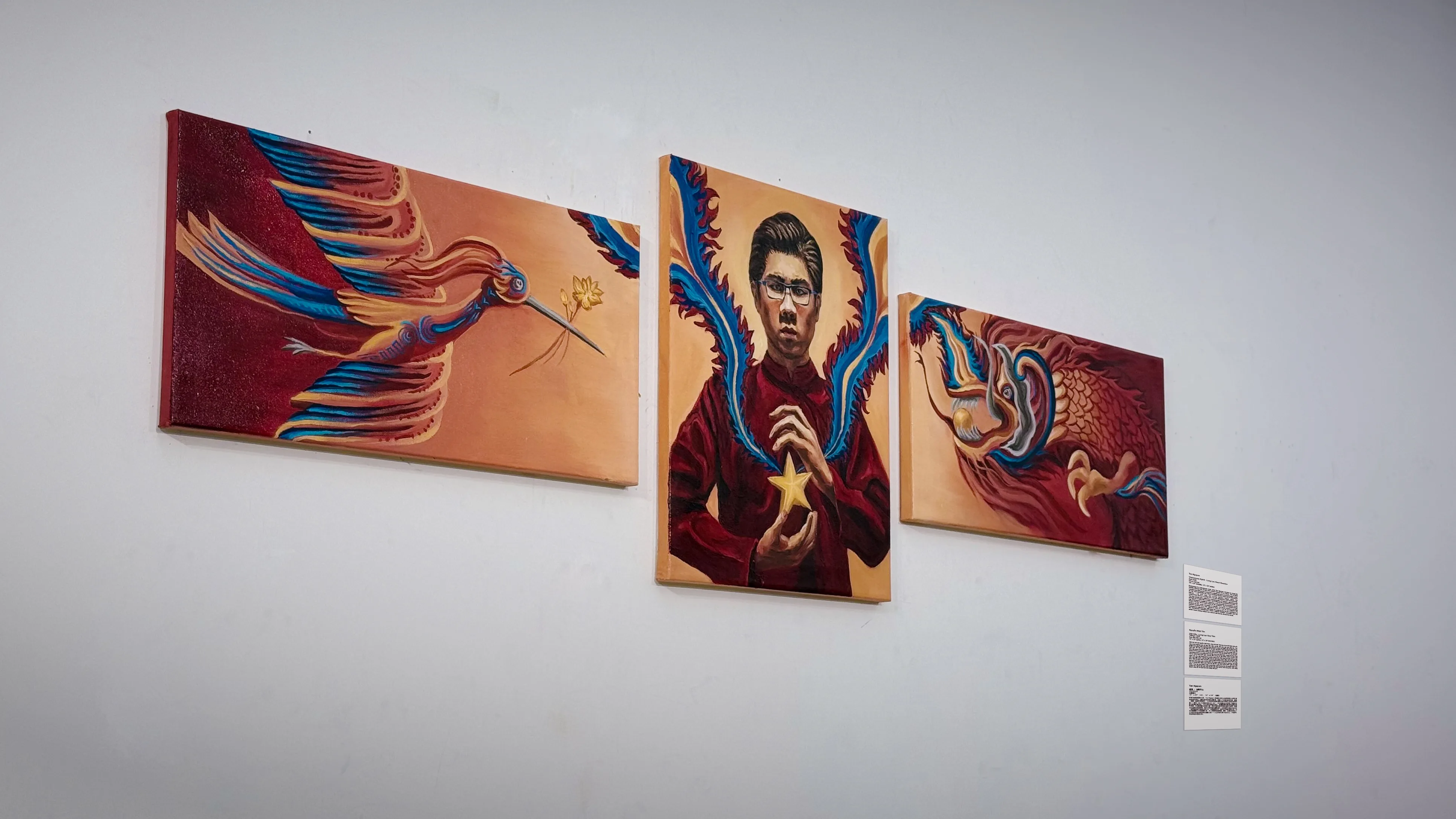 The three canvases of Vietnamese Spirit on the critique wall at an angle, with the printed project label at the right.