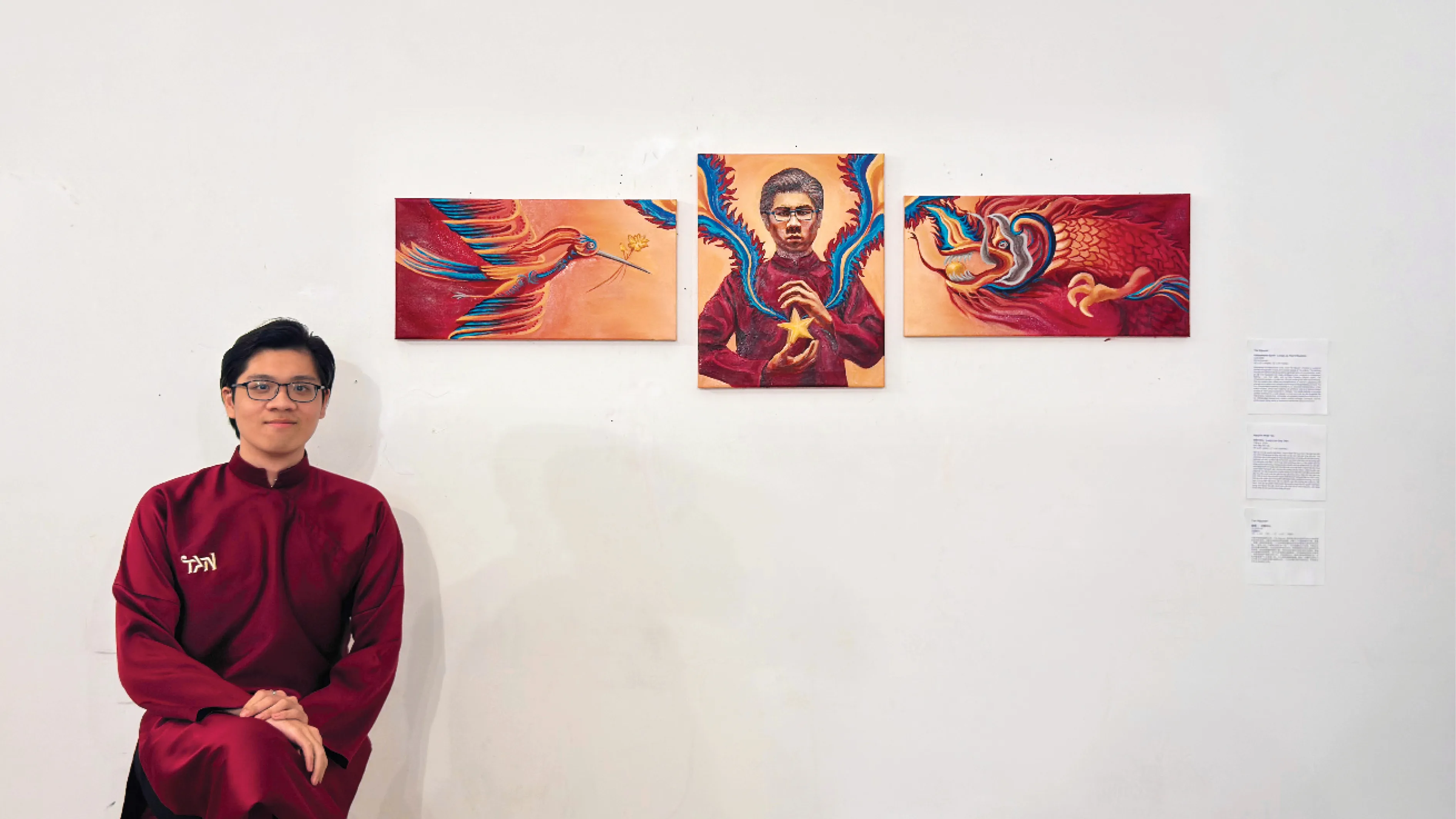 Tan Nguyen in a deep red Ao dai standing beside the Vietnamese Spirit triptych at its class critique, project label at right.