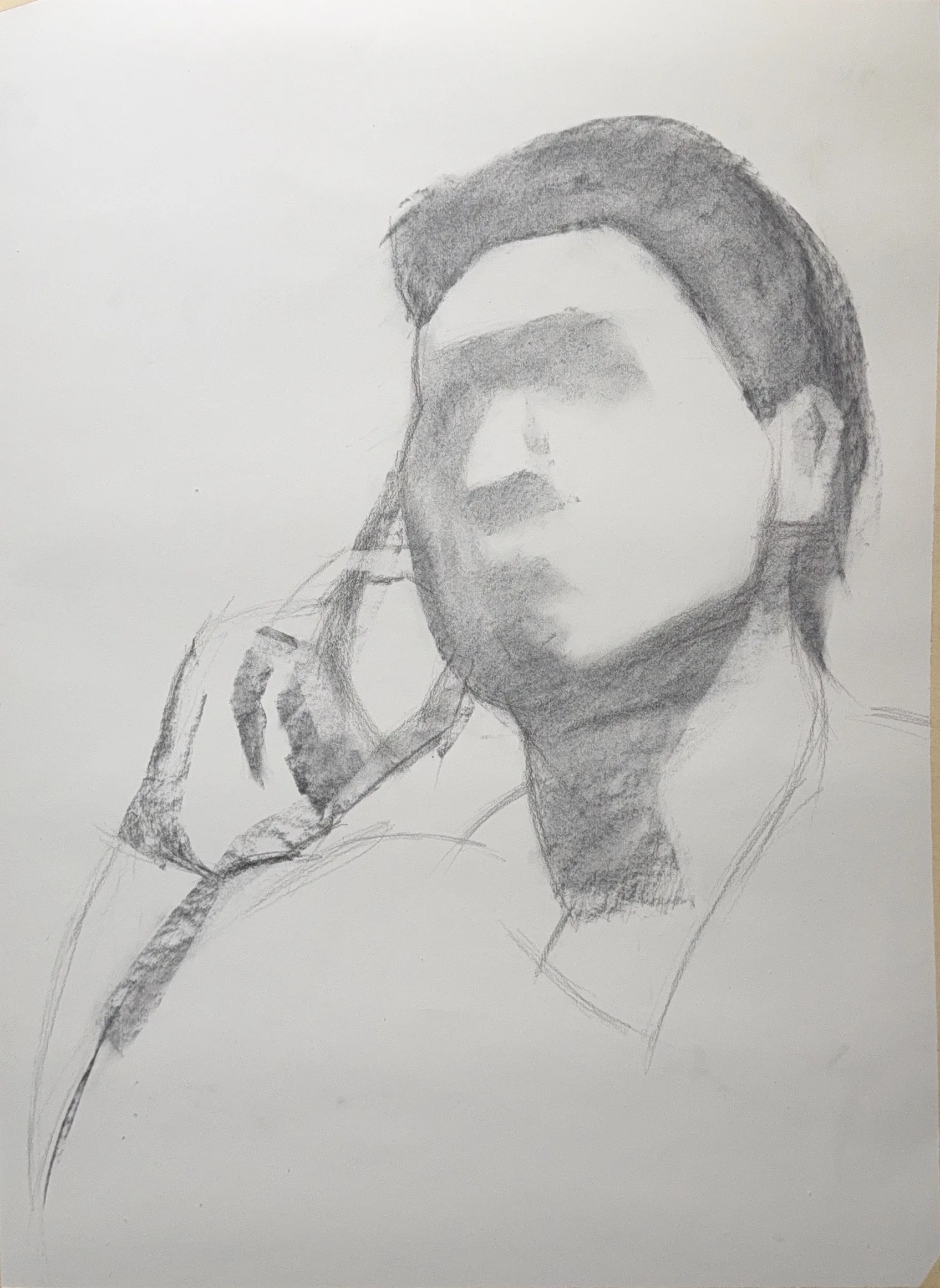 First charcoal stage, the head massed in softly with the features barely indicated and the hand roughed in at the chin.