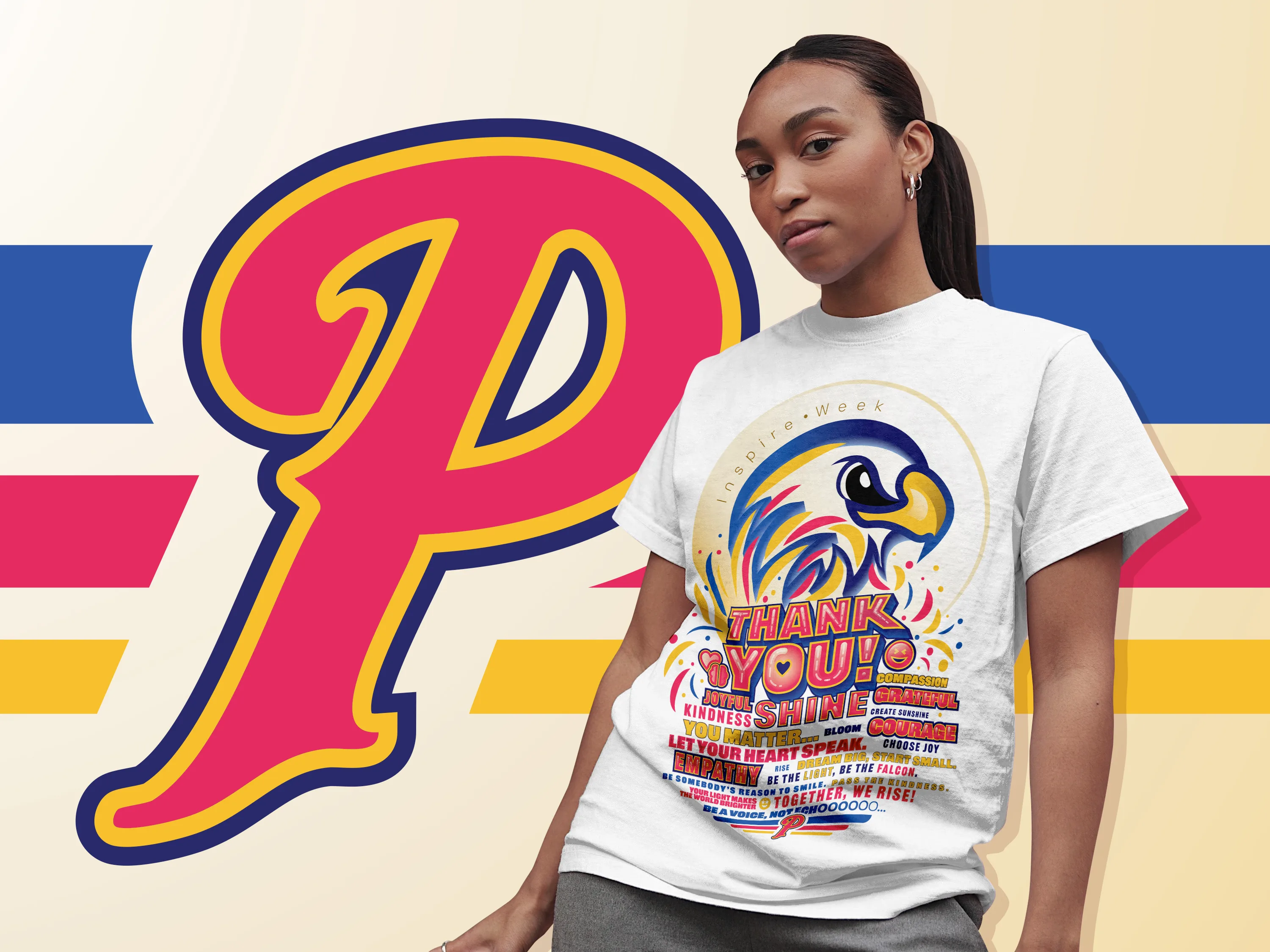 The Inspire Week shirt worn by a student, printed on white, photographed against a cream background with the large pink and navy Prairie P monogram behind her.