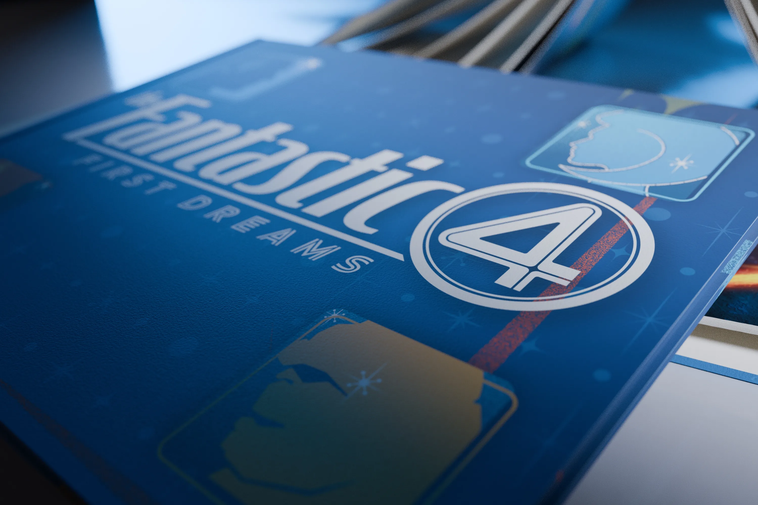 Close angled view of the artbook cover, raking light across the silver title and the circled four, with the edges of further copies stacked behind.